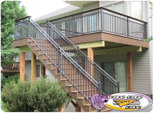 A second story deck with stairs to the lawn