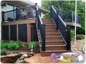 A low maintenance deck with black lattice work and steps down to the landscaped lawn